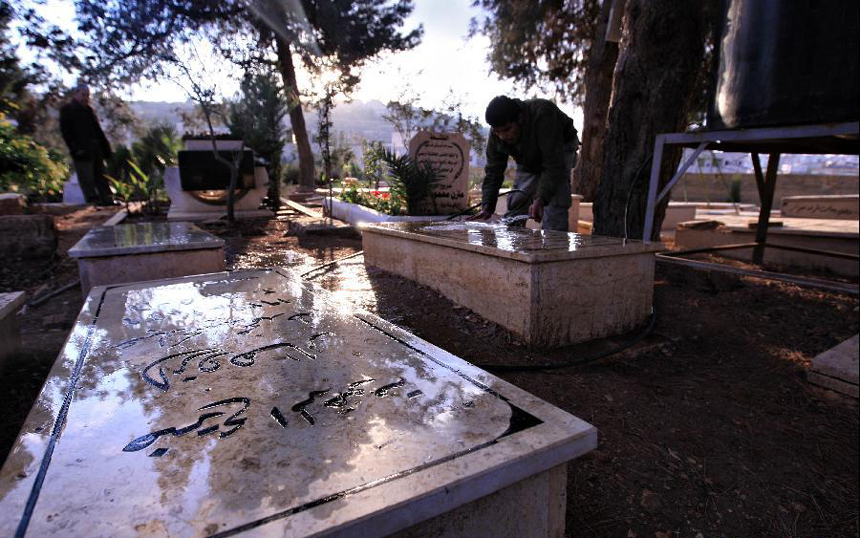 A Palestinian man washes a grave at a cemetery in the West Bank city of Ramallah on the first day of Eid al-Adha Nov.6, 2011. Muslims around the world celebrate Eid al-Adha to mark the end of the Hajj by slaughtering sheep, goats, cows and camels to commemorate Prophet Abraham's willingness to sacrifice his son Ismail on God's command.