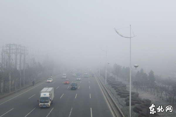 Road and vehicles are seen amid fog in Harbin, capital of northeast China's Heilongjiang Province, Nov. 6, 2011. Local meteorological department issued a 'yellow' fog alert on Sunday. China has a color-coded weather warning system: red, orange, yellow and blue. Blue is the least serious level.