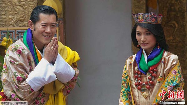 King of Bhutan Jigme Khesar Namgyel Wangchuck (L) and future queen Jetsun Pema stand together during their marriage ceremony in the main courtyard of the 17th-century fortified monastery or dzong in Punakha on October 13, 2011.