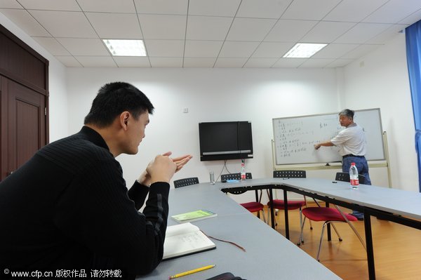 Yao Ming attends a math class during his first day as a student at Shanghai Jiao Tong University on Monday, Nov.7, 2011.