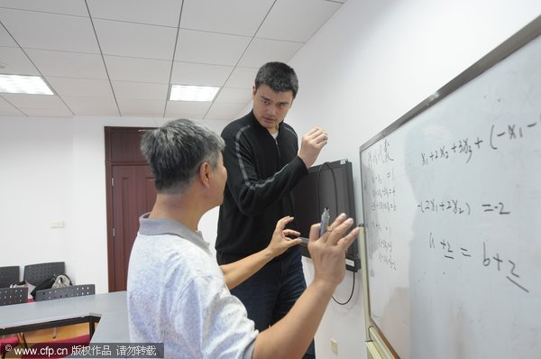 Yao Ming attends a math class during his first day as a student at Shanghai Jiao Tong University on Monday, Nov.7, 2011.