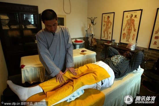 Mikael Pietrus of NBA's Phoenix Suns receives traditional Chinese physical treatment from a monk of the Shaolin Monastery, famous for its mastery in kungfu, or Chinese martial arts.