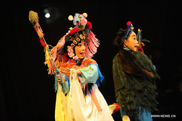Teenage Peking Opera fans Zhi Xuelian (L) and Fan Beibei perform on stage in Wuhan, central China's Hubei Province, Nov. 4, 2011. Dozens of Peking Opera fans from China and abroad held a show during the ongoing sixth Peking Opera Festival here Friday. 