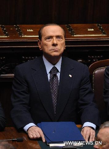 Italian Prime Minister Silvio Berlusconi looks on during a crucial vote at the parliament in Rome, Italy, Nov. 8, 2011. Berlusconi said Tuesday that he would resign after stability measures were approved following a meeting with President Giorgio Napolitano, according to a statement published by the Italian President Palace. [Wang Qingqin/Xinhua] 