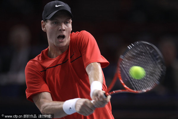 Tomas Berdych of Czech Republic returns the ball to Fernando Verdasco of Spain during their match in the Paris Tennis Masters tournament on Tuesday, Nov.8, 2011.