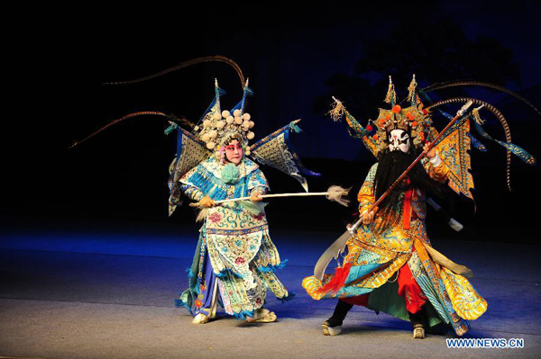 Qi Shufang (L), founder of Qi Shufang Peking Opera Troupe, performs in the opera 'The Women Generals of the Yang Family' during the 6th China Peking Opera Art Festival in Wuhan City, capital of central China's Hubei Province, Nov. 8, 2011.