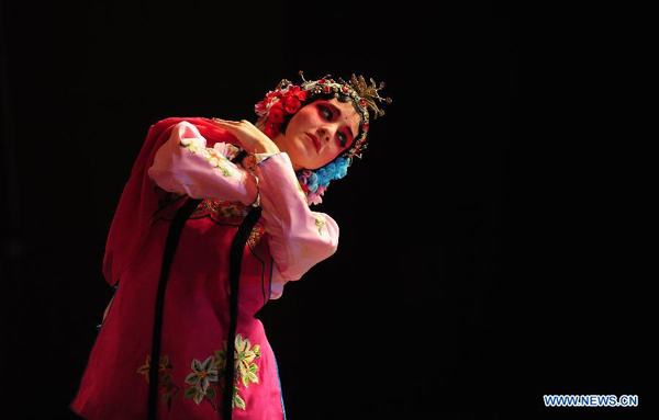 Stephanie Willing, a member of Qi Shufang Peking Opera Troupe, performs in the opera 'Pick up Jade Bracelet' during the 6th China Peking Opera Art Festival in Wuhan City, capital of central China's Hubei Province, Nov. 8, 2011. 