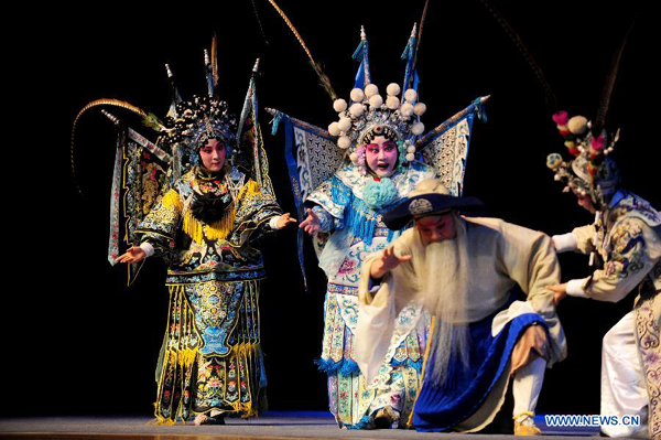Qi Shufang (2nd, L), founder of Qi Shufang Peking Opera Troupe, performs in the opera 'The Women Generals of the Yang Family' during the 6th China Peking Opera Art Festival in Wuhan City, capital of central China's Hubei Province, Nov. 8, 2011.