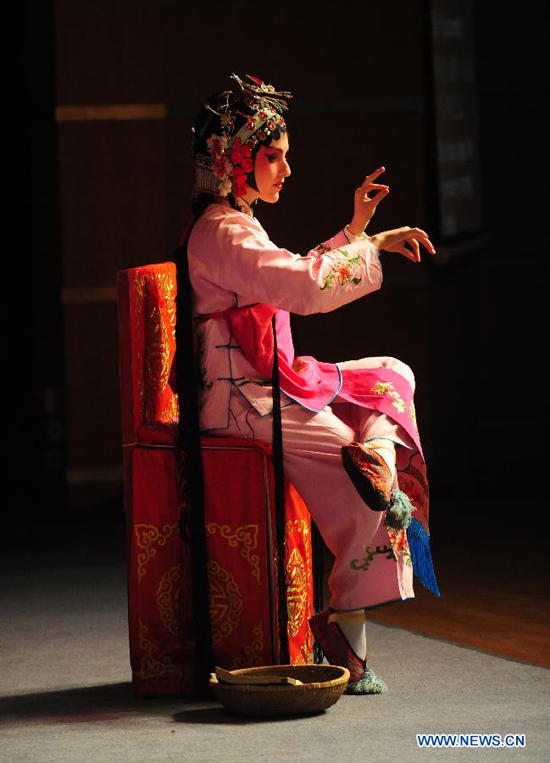 Stephanie Willing, a member of Qi Shufang Peking Opera Troupe, performs in the opera 'Pick up Jade Bracelet' during the 6th China Peking Opera Art Festival in Wuhan City, capital of central China's Hubei Province, Nov. 8, 2011. 