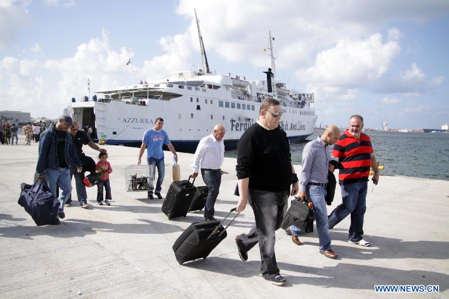 Passengers from Malta disembark after arriving at a harbor in Tripoli, Libya, Nov. 10, 2011. The passenger liner has been resumed between Libya and Malta. [Hamza Turkia/Xinhua]