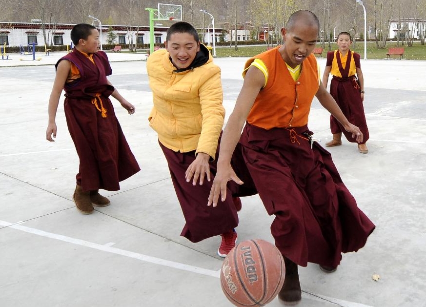 Lama students play basketball at school in the Tibet College of Buddhism in Lhasa, capital of southwest China's Tibetan Autonomous Region, Nov. 7, 2011. 