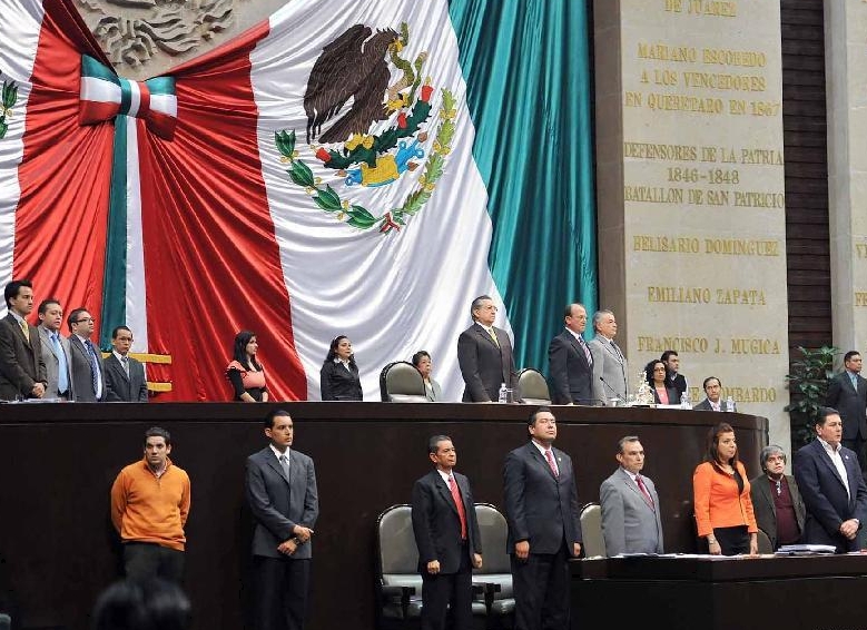 Representatives of the Mexican Congress stand in silent tribute to deceased Mexican Interior Minister Francisco Blake Mora, in Mexico City, capital of Mexico, on Nov. 11, 2011. Mexican Interior Minister Francisco Blake Mora and Vice Interior Minister Felipe Zamora were killed in a helicopter crash on Friday, official sources said.