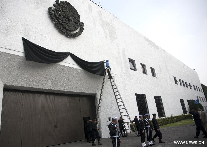 Workers put a black ribbon in honor of deceased Mexican Interior Minister Francisco Blake Mora, at the entrance of the presidential palace Los Pinos in Mexico City, capital of Mexico, on Nov. 11, 2011. Mexican Interior Minister Francisco Blake Mora and Vice Interior Minister Felipe Zamora were killed in a helicopter crash on Friday, official sources said. 