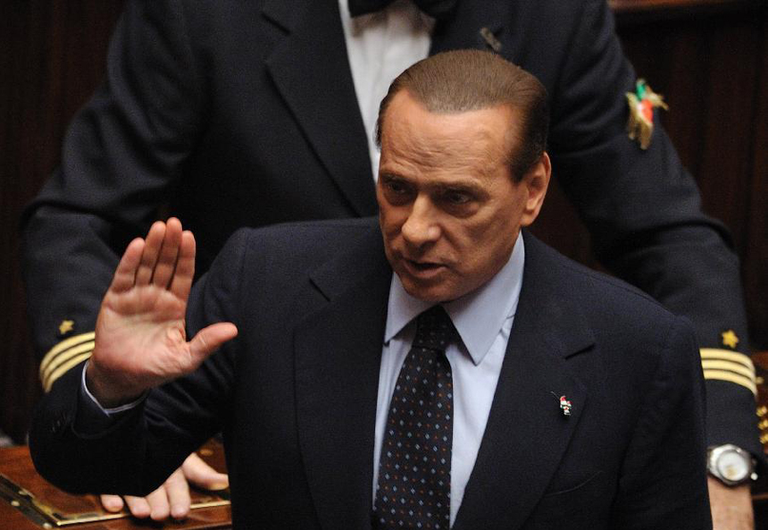 Italian Prime Minister Silvio Berlusconi waves at supporters upon his arrival for a vote on the austerity measures for 2012 at the lower house of parliament in Rome, Italy, Nov. 12, 2011. Italian Prime Minister Silvio Berlusconi resigned Saturday night after a package of austerity measures demanded by the European Union (EU) was passed in both chambers of Italian parliament, the ANSA news agency reported. 