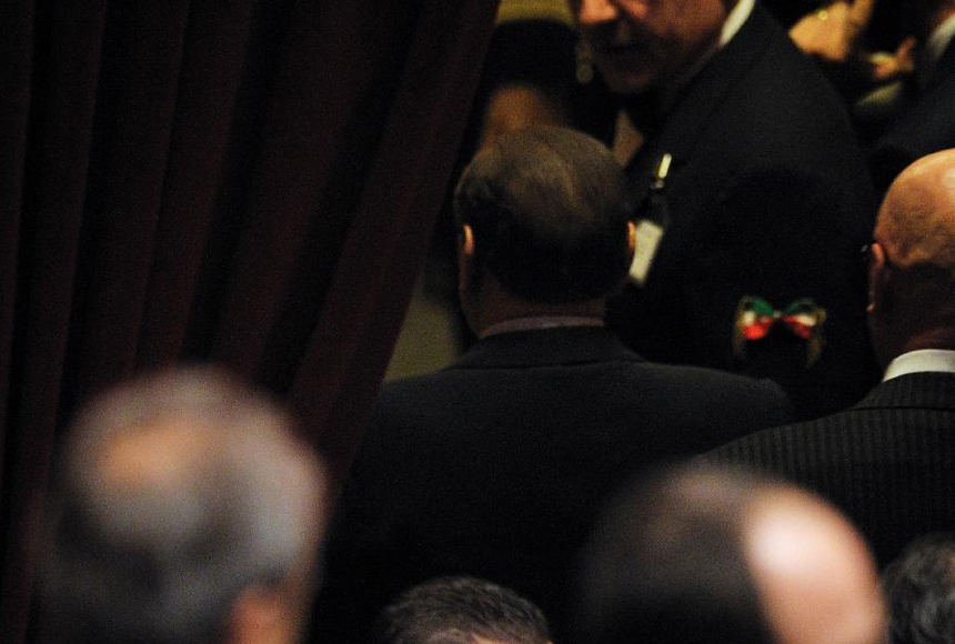 Italian Prime Minister Silvio Berlusconi leaves after the approval of the austerity measures for 2012 at the lower house of parliament in Rome, Italy, Nov. 12, 2011. Italian Prime Minister Silvio Berlusconi resigned Saturday night after a package of austerity measures demanded by the European Union (EU) was passed in both chambers of Italian parliament, the ANSA news agency reported. 