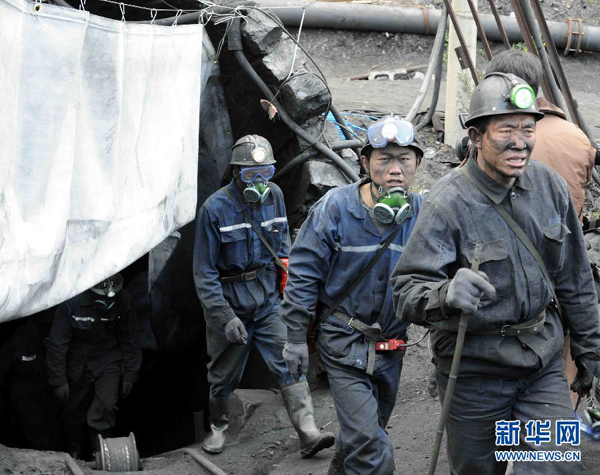 Rescue workers walk out of the Shizong Coal Mine, Yunnan Province, on Nov. 13, 2011. Thirty four miners have been confirmed dead after a gas leak occurred in a coal mine in southwest China's Yunnan Province Thursday morning. 