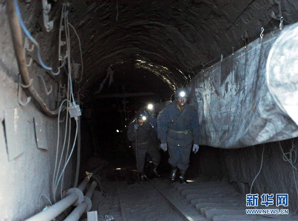 Rescue workers walk out of the Shizong Coal Mine, Yunnan Province, on Nov. 13, 2011. Thirty four miners have been confirmed dead after a gas leak occurred in a coal mine in southwest China's Yunnan Province Thursday morning. 