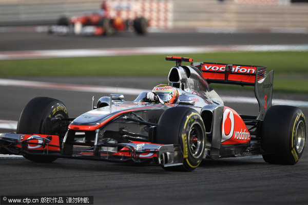 Mclaren Mercedes driver Lewis Hamilton steers his car as Ferrari Spanish driver, Fernando Alonso follows him during the Emirates Formula One Grand Prix at the Yas Marina racetrack, in Abu dhabi, United Arab Emirates on Sunday, Nov. 13, 2011.