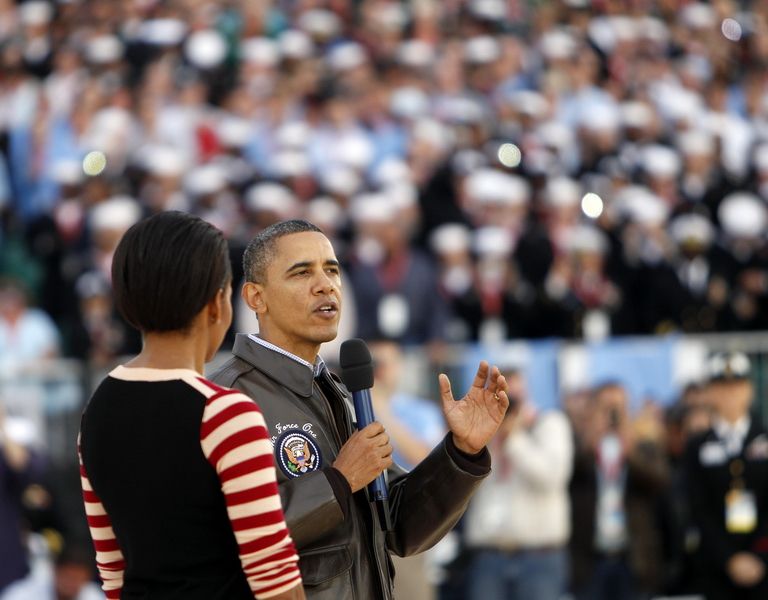 U.S. President Barack Obama and first lady Michelle Obama speak to the crowd before the start of the NCAA men's college basketball Carrier Classic between the Michigan State Spartans and the North Carolina Tar Heels aboard the flight deck of the USS Carl Vinson on November 11, 2011 in San Diego, California.