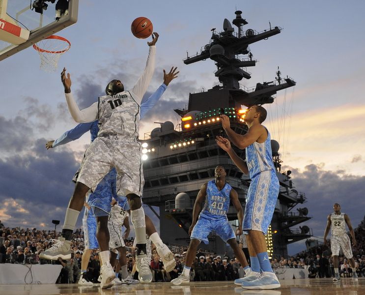  Michigan State forward Draymond Green (10) pulls down a rebound against North Carolina during the first half of the Carrier Classic NCAA college basketball game aboard the USS Carl Vinson on November 10, 2011 in San Diego, California.