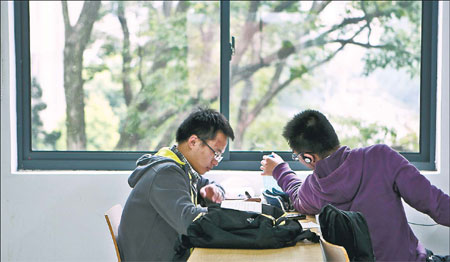 Two young teens spend time in study hall after enrolling this year at the University of Science and Technology of China. Every year about 3,000 apply to the School of the Gifted Young and about 50 are admitted. [Photo / China Daily]