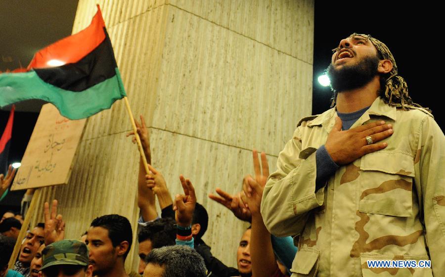 Libyan youths participate in a protest demanding that the Libyan Transitional National Council stop the clashes between fighters from Zawiya and the Warcfana tribe, Tripoli, Libya, Nov. 14, 2011. [Qin Haishi/Xinhua] 