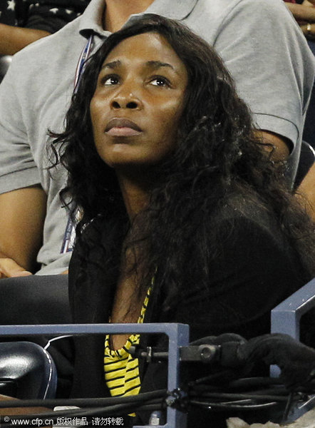Venus Williams watches her sister Serena during a semifinal match against Caroline Wozniacki of Denmark at the U.S. Open tennis tournament in New York on Saturday, Sept. 10, 2011.