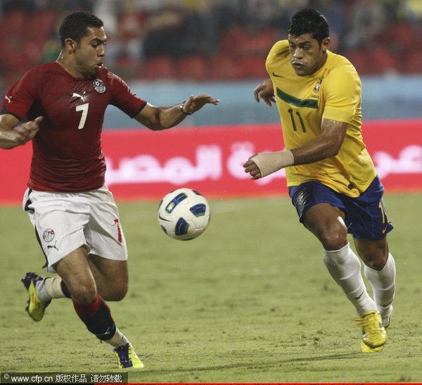 Hulk, from Brazil, fights for the ball with Armed Fathi from Egypt, during a FIFA friendly match at Al Rayyan stadium on November 14, 2011 in Doha, Qatar. 