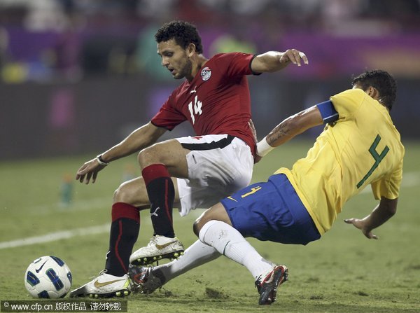 Brazil's Thiago Silva (right) fights for the ball with Egypt's Hossam Ghaly during their international friendly match in Doha, Qatar on Monday Nov. 14, 2011.