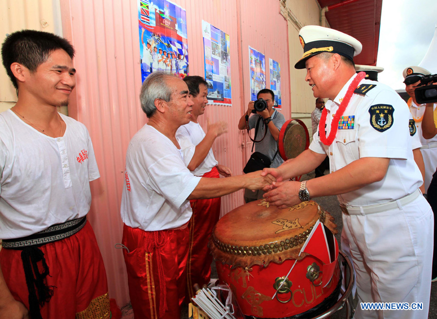 Qiu Yanpeng (1st R), commander of the Chinese Navy &apos;Peace Ark&apos; hospital ship, shakes hands with overseas Chinese before the ship departs from Port of Spain, Trinidad and Tobago, Nov. 15, 2011. The Chinese Navy &apos;Peace Ark&apos; hospital ship is heading for Costa Rica to continue the humanitarian medical services after concluding its seven-day mission in Trinidad and Tobago. [Zha Chunming/Xinhua] 