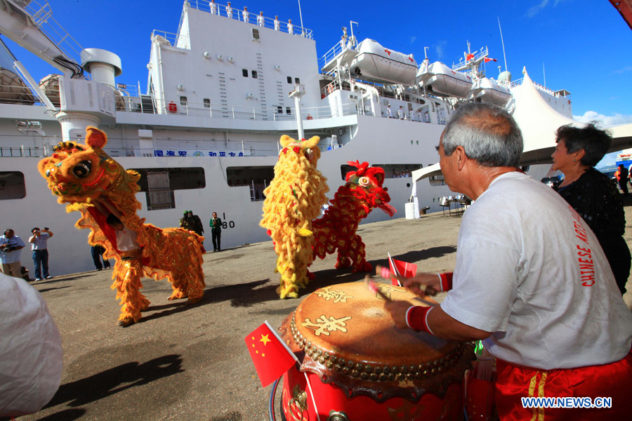 Overseas Chinese perform traditional dragon and lion dance before the Chinese Navy &apos;Peace Ark&apos; hospital ship departs from Port of Spain, Trinidad and Tobago, Nov. 15, 2011. The Chinese Navy &apos;Peace Ark&apos; hospital ship is heading for Costa Rica to continue the humanitarian medical services after concluding its seven-day mission in Trinidad and Tobago. [Zha Chunming/Xinhua]