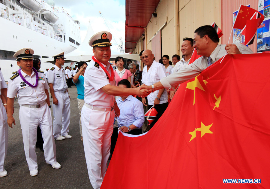 Qiu Yanpeng (C), commander of the Chinese Navy &apos;Peace Ark&apos; hospital ship, shakes hands with overseas Chinese before the ship departs from Port of Spain, Trinidad and Tobago, Nov. 15, 2011. The Chinese Navy &apos;Peace Ark&apos; hospital ship is heading for Costa Rica to continue the humanitarian medical services after concluding its seven-day mission in Trinidad and Tobago. [Zha Chunming/Xinhua] 