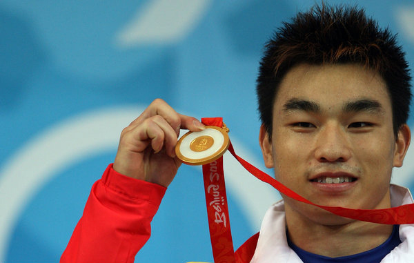 Liao Hui of China celebrates his gold medal in the weightlifting event held at the Beijing University of Aeronautics and Astronautics Gymnasium during Day 4 of the Beijing 2008 Olympic Games on August 12, 2008 in Beijing.