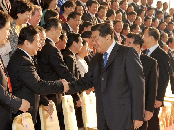 Jia Qinglin (R, front), chairman of the National Committee of the Chinese People's Political Consultative Conference (CPPCC), who is also a member of the Standing Committee of the Communist Party of China (CPC) Central Committee Political Bureau, shakes hands with participants at a meeting on ethnic policies held in Nanning, capital of Guangxi Zhuang Autonomous Region in southwest China, Nov. 18, 2011. [Ma Zhancheng/Xinhua]