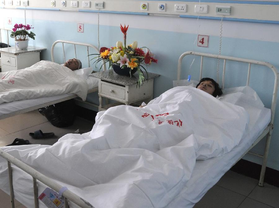 Miners receive medical treatment at a hospital after being rescued from the caved-in Yuanlin Coal Mine in Xianghuang banner (county) of Xilin Gol league, north China's Inner Mongolia Autonomous Region, Nov. 19, 2011. 