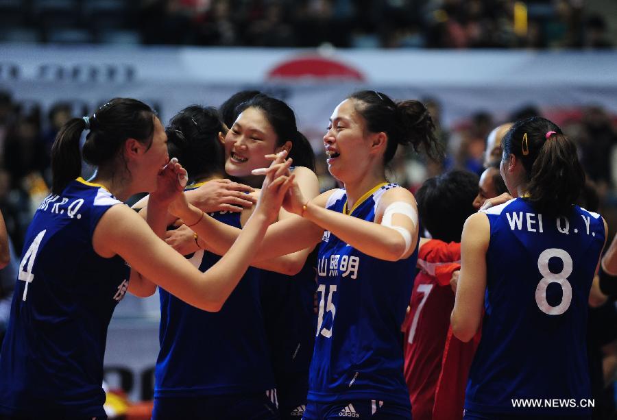 Players of China celebrate their victory over Germany at the World Cup women's volleyball tournament in Tokyo, Japan, on Nov. 18, 2011. China beat Germany 3-0 here in their last match of the event and secured a London 2012 Olympic Games ticket, with the third ranking on the final World Cup Standing. [Ji Chunpeng/Xinhua]