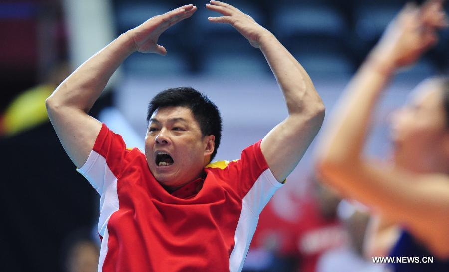 China's coach Yu Juemin reacts in the match against Germany at the World Cup women's volleyball tournament in Tokyo, capital of Japan, Nov. 18, 2011. China beat Germany 3-0 (25-18, 25-18, 25-21) ensuring a place at the London Olympic games 2012. [Ji Chunpeng/Xinhua]