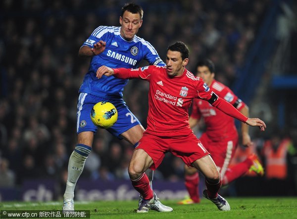 Maxi Rodriguez of Liverpool is closed down by John Terry of Chelsea during the Barclays Premier League match between Chelsea and Liverpool at Stamford Bridge on November 20, 2011 in London, England.