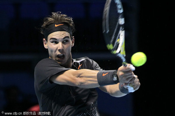 Spain's Rafael Nadal plays a return to Mardy Fish of the U.S. during a round robin single tennis match at the ATP World Tour Finals at o2 Arena in London on Sunday, Nov. 20, 2011.