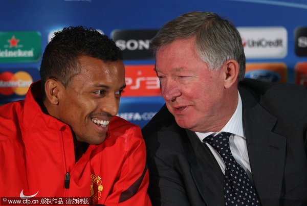 Sir Alex Ferguson the manager of Manchester United talks with Nani during a press conference ahead of the UEFA Champions League Group C match against Benfica held at Old Trafford on November 21, 2011 in Manchester, England.