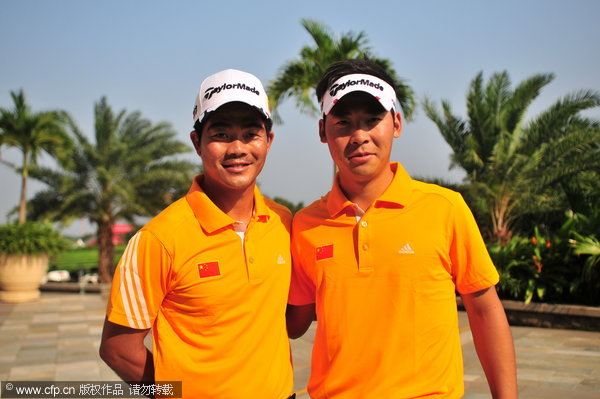 Liang Wenchong (L) and Zhang Xinjun (R) at the Mission Hills Resort in Haikou, Hainan Province.
