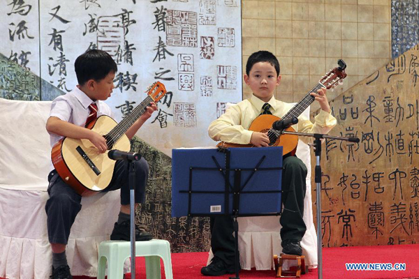 Two Chinese primary school boy perform during the Open Day event organized by Chinese Consulate-General in Sydney, Australia, on Nov. 23, 2011. 