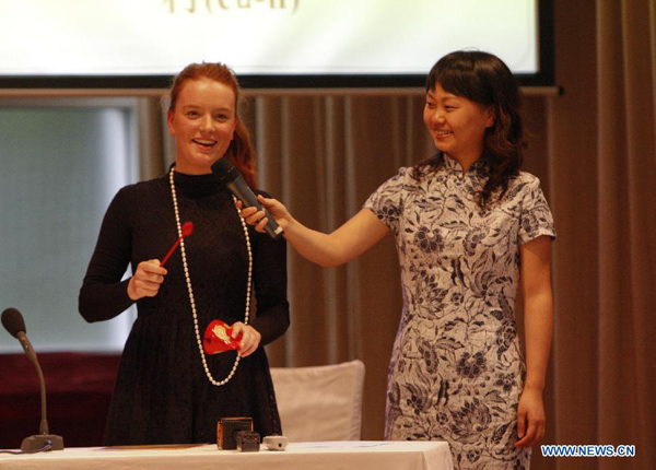 Jennifer Eileen (L) from the University of Sydney, also the Sydney Division title of the 10th Chinese Bridge-Chinese Proficiency Competition for Foreign College Students, performs during the Open Day event organized by Chinese Consulate-General in Sydney, Australia, on Nov. 23, 2011. 