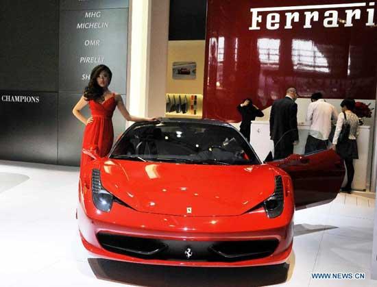 A model shows a Ferrari roadster at the 9th Guangzhou Auto Show in Guangzhou, south China, on Nov. 24, 2011. Themed as 'Green Techonology and Harmonious Future', the 9th Guangzhou International Automobile Exhibition displayed 900 automobiles, including 30 world premiered cars and 54 new energy vehicles. [Chen Yehua/Xinhua]