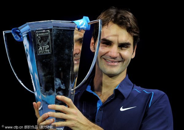 Roger Federer of Switzerland holds the trophy following his victory during the men's final singles match against Jo-Wilfried Tsonga of France during the Barclays ATP World Tour Finals at the O2 Arena on November 27, 2011 in London, England. 