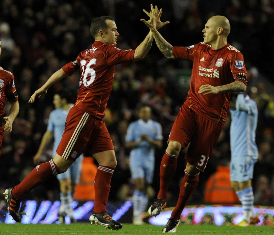 Liverpool's Charlie Adam (2nd L) and Martin Skrtel (R) celebrate after Adam's shot was deflected into the goal by Manchester City's Joleon Lescott in their English Premier League soccer match in Liverpool, northern England November 27, 2011. (Xinhua/Reuters Photo) 