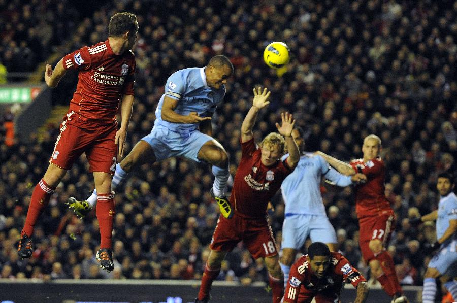 Manchester City's Vincent Kompany (2nd L) heads to score against Liverpool during their English Premier League soccer match in Liverpool, northern England November 27, 2011. (Xinhua/Reuters Photo) 