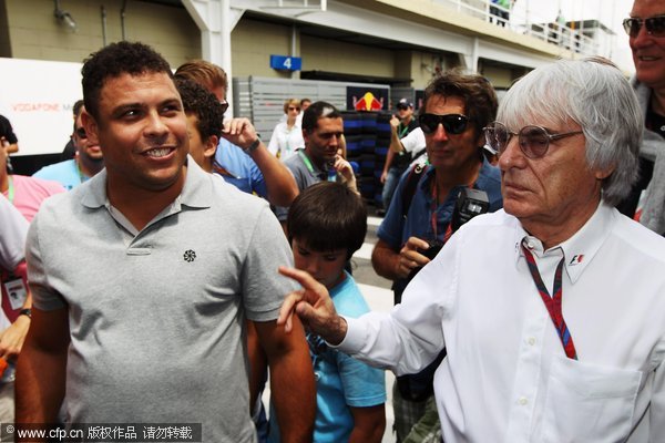 F1 supremo Bernie Ecclestone is seen with former Brazilian footballer Ronaldo in the paddock before the Brazilian Formula One Grand Prix at the Autodromo Jose Carlos Pace on November 27, 2011 in Sao Paulo, Brazil.