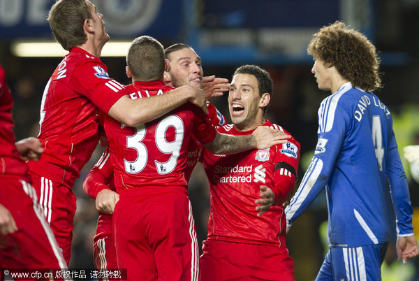 Liverpool's Maxi Rodriguez celebrates with team mates after scoring against Chelsea during their English League Cup quarter final match at the Stamford Bridge stadium in London on Tuesday, Nov. 29, 2011.