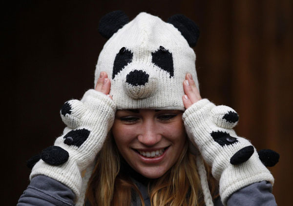 Edinburgh Zoo panda team member Lisa Baxter poses for photographers wearing a panda knit hat and gloves at the the new enclosure area ahead of the arrival of two giant pandas from China in Edinburgh Zoo, Scotland November 29, 2011. 